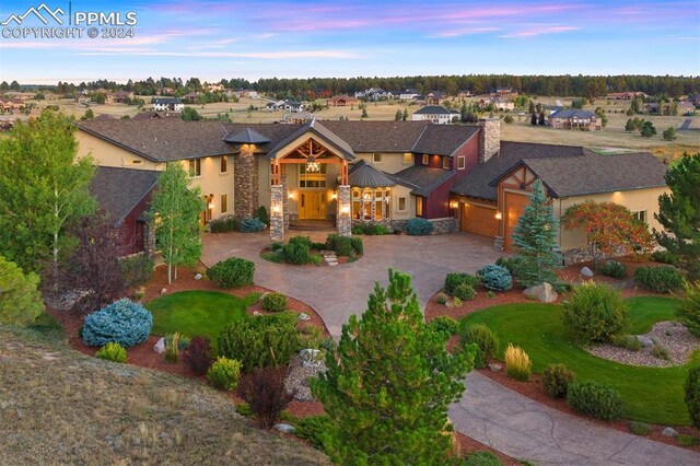 19155 Lochmere Ct, Monument, CO 80132 - view of front facade featuring curved driveway, an attached garage, stone siding, stucco siding, and a residential view