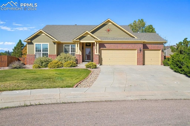 view of front facade featuring a front lawn and a garage