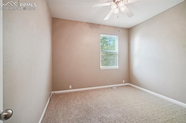 spare room with carpet and ceiling fan