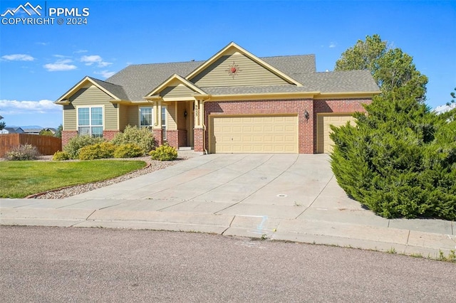 view of front of property featuring a front yard and a garage