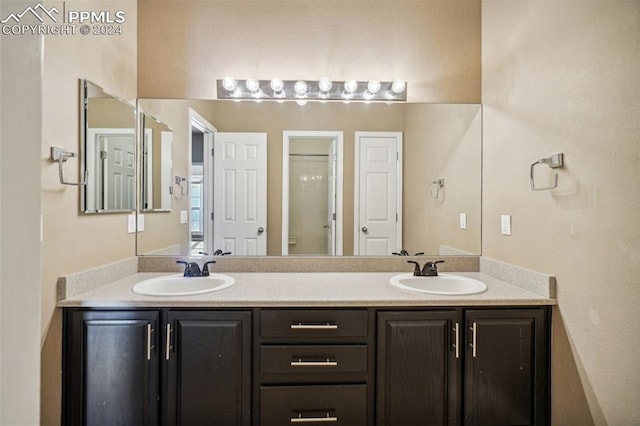 bathroom featuring vanity and a shower with shower door