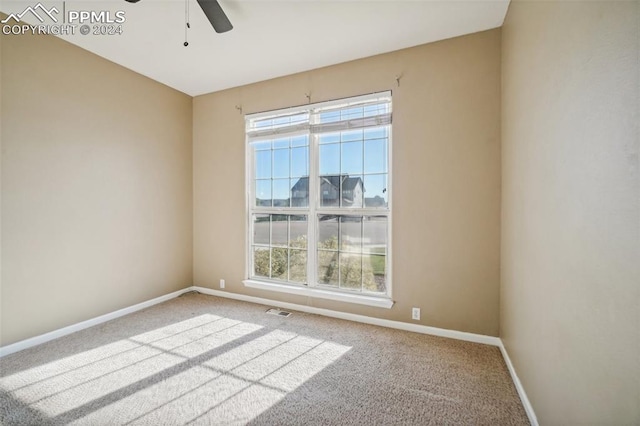 spare room featuring carpet floors and ceiling fan