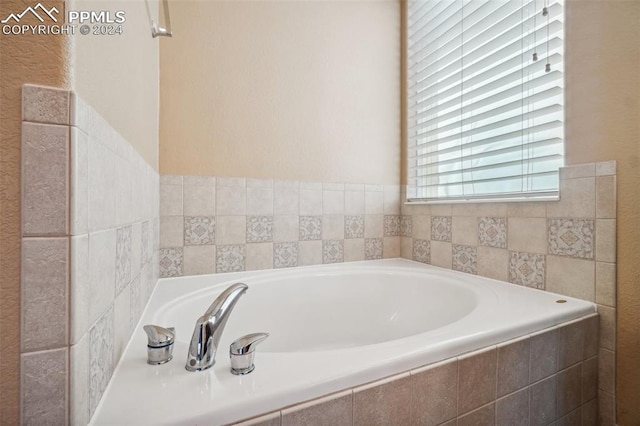 bathroom with tiled tub