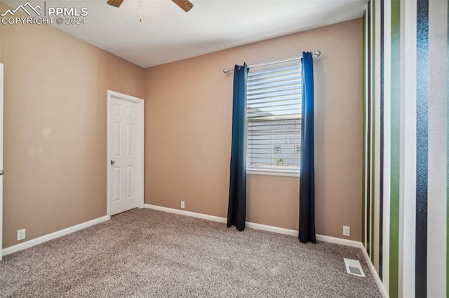 carpeted empty room with ceiling fan