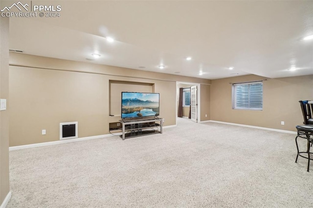 living area featuring light carpet