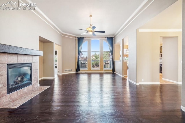 unfurnished living room featuring wood-type flooring, a fireplace, crown molding, and ceiling fan