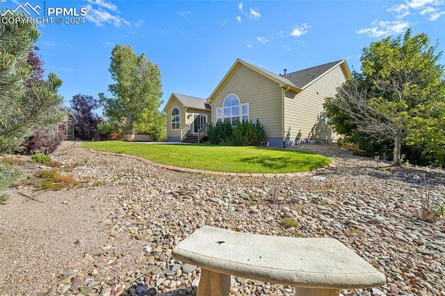 view of side of property with a lawn