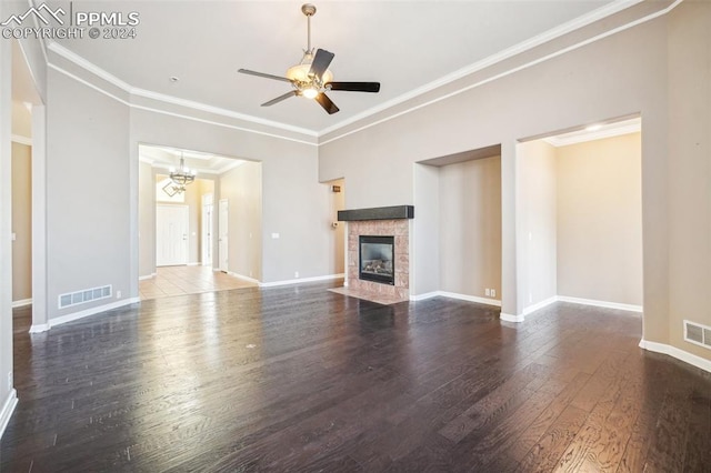 unfurnished living room featuring a fireplace, ornamental molding, ceiling fan, and dark wood-type flooring