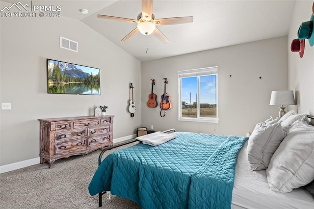 carpeted bedroom with ceiling fan and vaulted ceiling