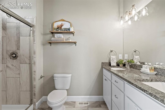 bathroom with vanity, toilet, and an enclosed shower