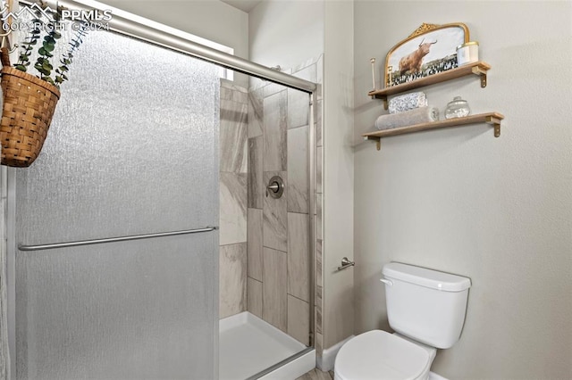 bathroom with walk in shower and toilet