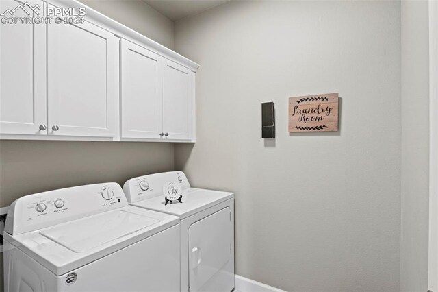 laundry area with washer and clothes dryer and cabinets