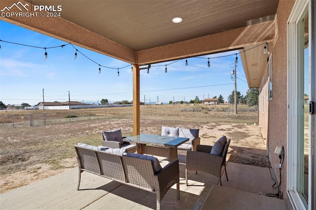 view of patio with a rural view and an outdoor living space