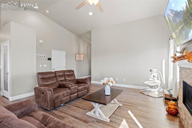 living room with high vaulted ceiling, ceiling fan, and wood-type flooring