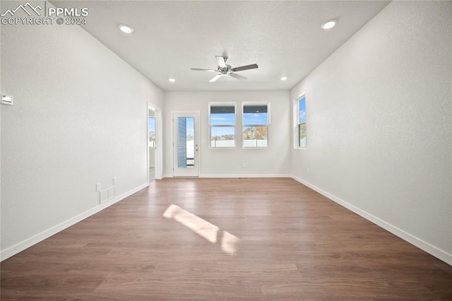 unfurnished room featuring ceiling fan and dark hardwood / wood-style floors