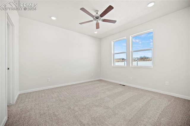 empty room with light carpet and ceiling fan