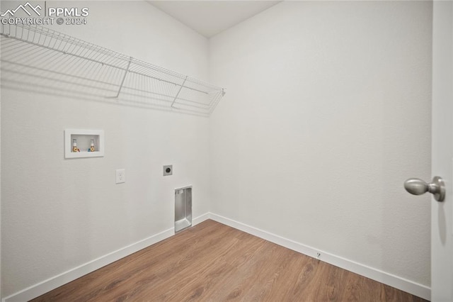 washroom featuring hookup for a washing machine, hardwood / wood-style floors, and electric dryer hookup