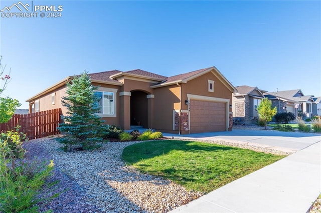 view of front facade featuring a front yard and a garage