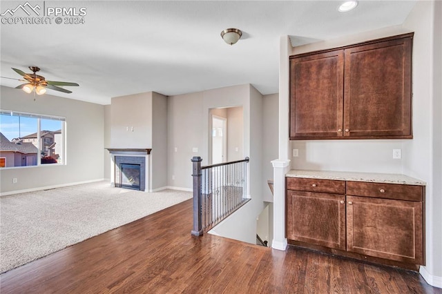 kitchen featuring dark brown cabinets, dark wood-type flooring, and ceiling fan