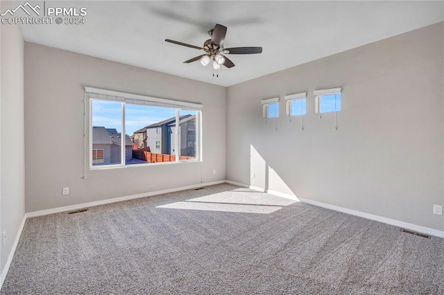 spare room with ceiling fan and carpet floors