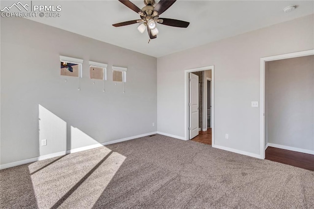 interior space featuring ceiling fan and dark colored carpet