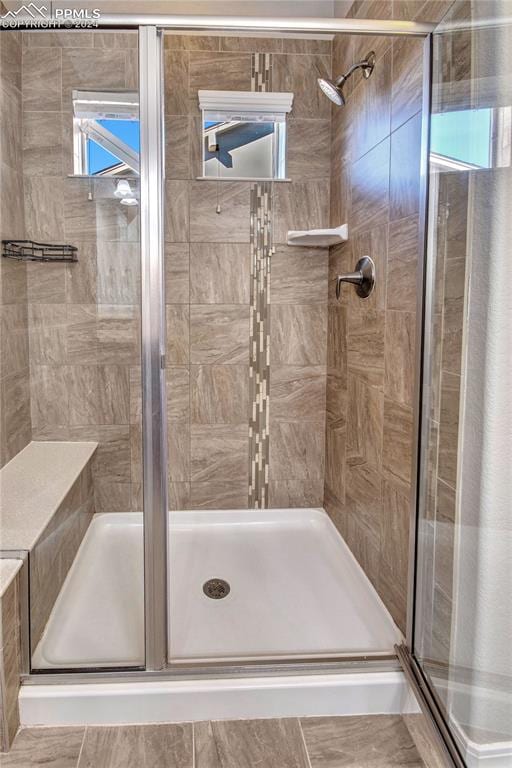 bathroom featuring a shower with shower door