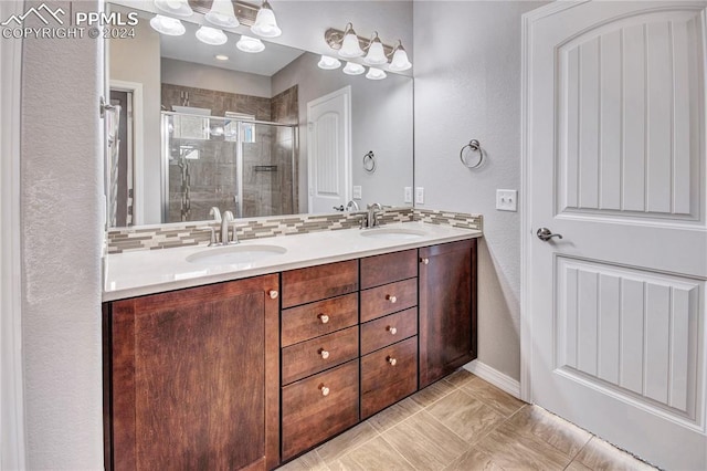 bathroom featuring vanity and a shower with door