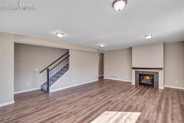 unfurnished living room with a fireplace and hardwood / wood-style floors