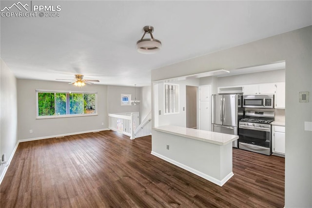 kitchen with dark wood-type flooring, appliances with stainless steel finishes, and white cabinets