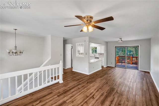 interior space featuring dark hardwood / wood-style floors, sink, and ceiling fan with notable chandelier