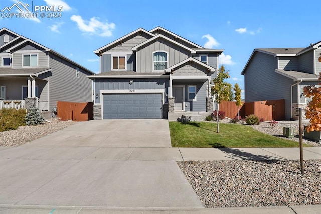 craftsman-style home with a garage and a front lawn