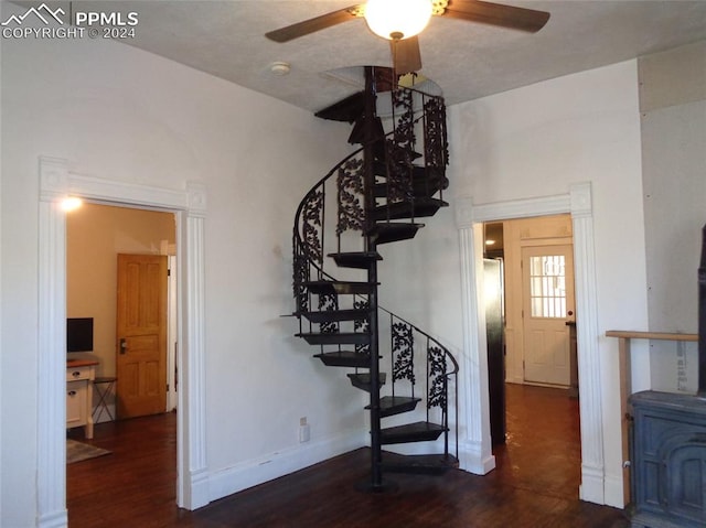 stairway with ceiling fan and hardwood / wood-style floors