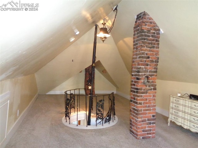 bonus room with lofted ceiling and carpet