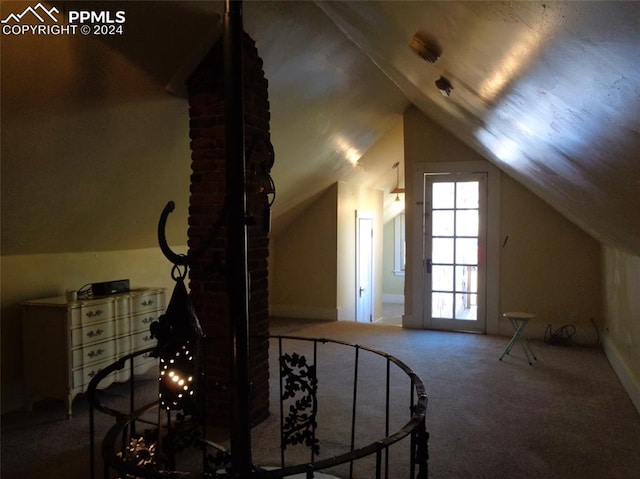 additional living space featuring vaulted ceiling and carpet flooring