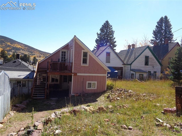 rear view of house featuring a mountain view