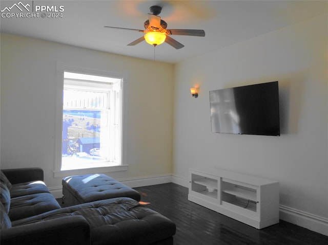 living room with dark hardwood / wood-style floors, ceiling fan, and plenty of natural light