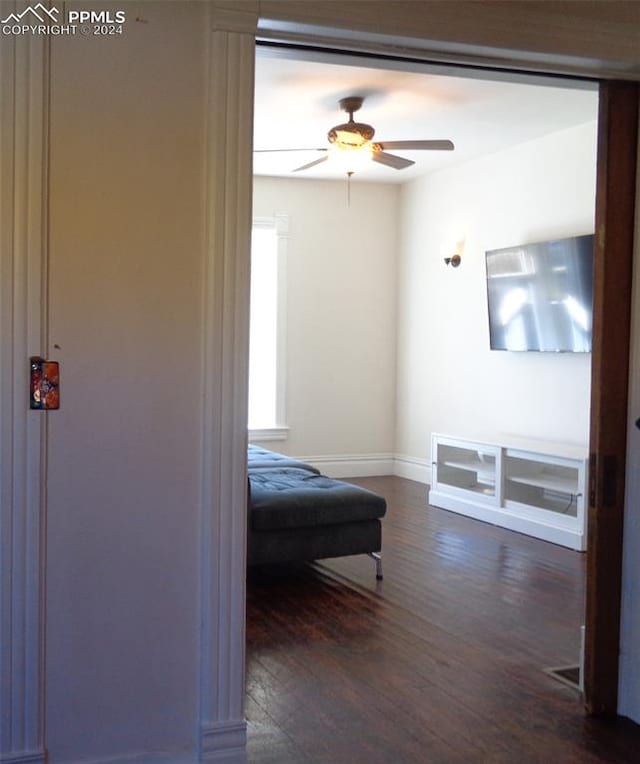 bedroom with dark hardwood / wood-style flooring and ceiling fan