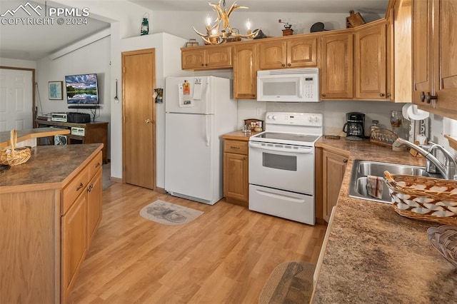 kitchen with light hardwood / wood-style floors, sink, lofted ceiling, an inviting chandelier, and white appliances