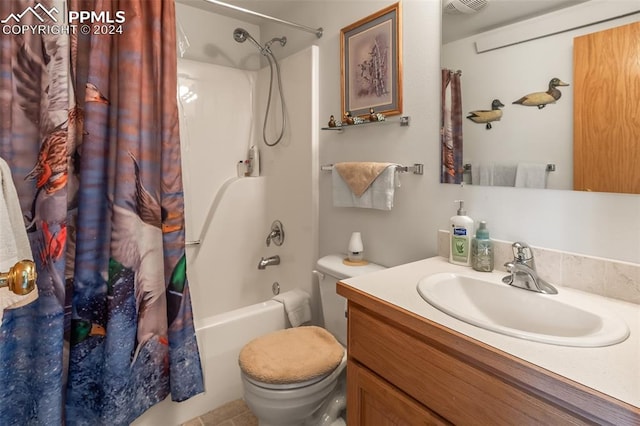 full bathroom with tile patterned floors, shower / bath combo, vanity, and toilet