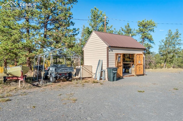 view of outbuilding with a carport