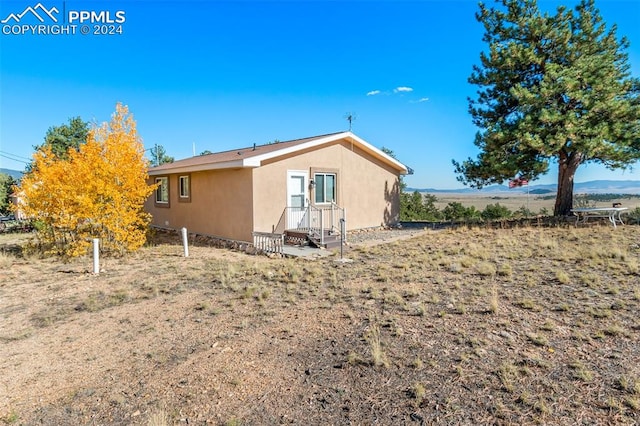 back of property with a mountain view