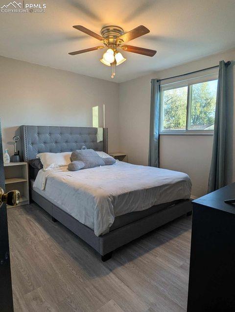 bedroom with wood-type flooring and ceiling fan