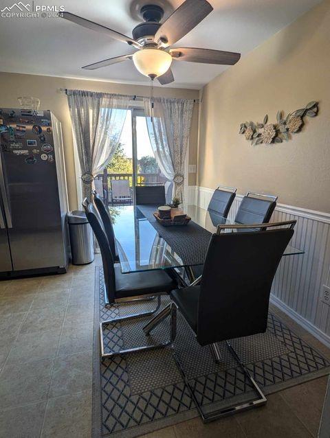 dining room featuring ceiling fan and tile patterned floors