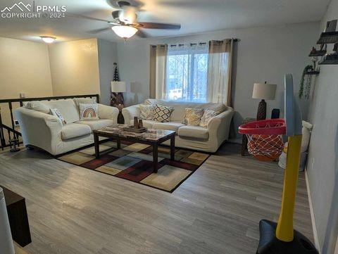 living room with hardwood / wood-style floors and ceiling fan