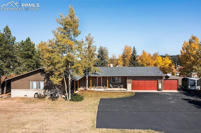 ranch-style home featuring a garage