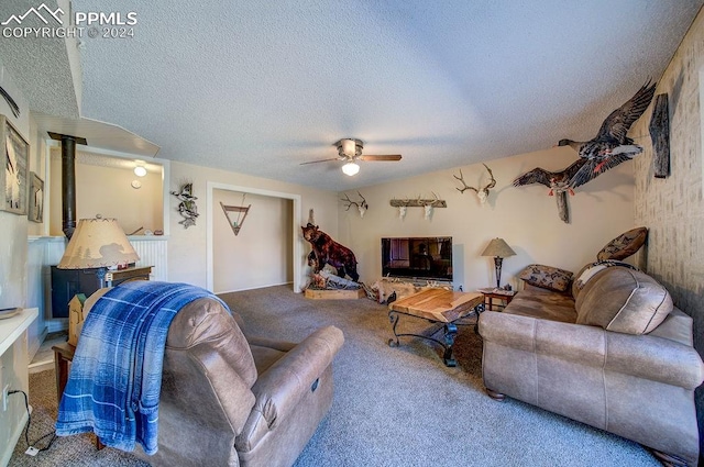 living room with a textured ceiling, carpet floors, and ceiling fan