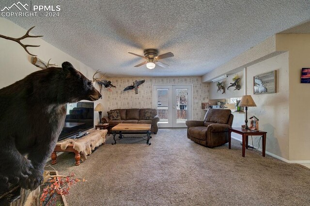 carpeted living room featuring french doors, a textured ceiling, and ceiling fan