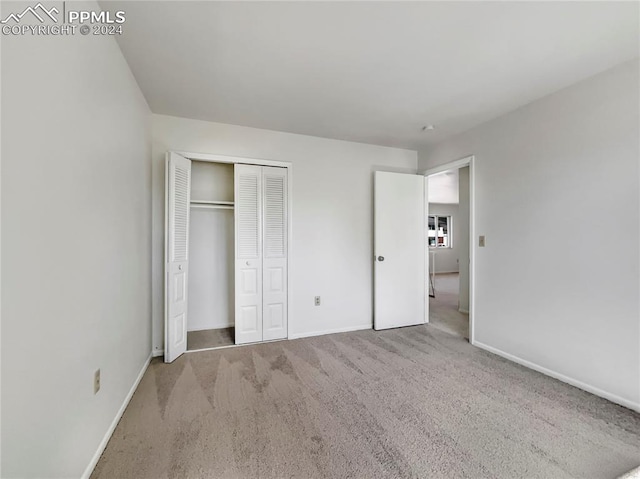 unfurnished bedroom with a closet and carpet floors