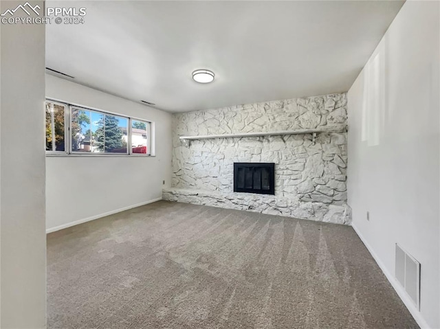 unfurnished living room with carpet floors and a fireplace