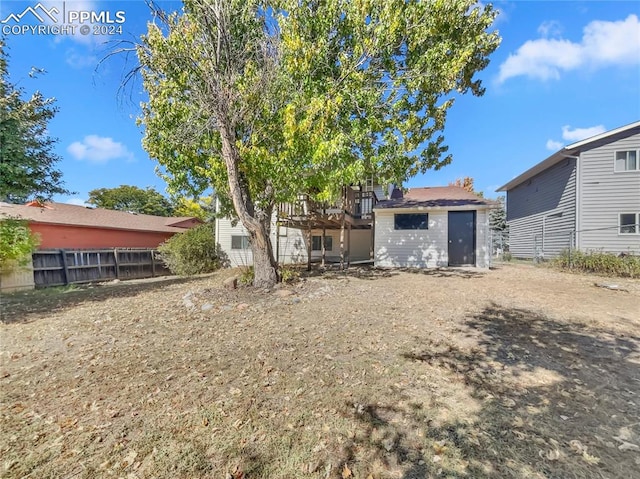 back of property with a storage shed